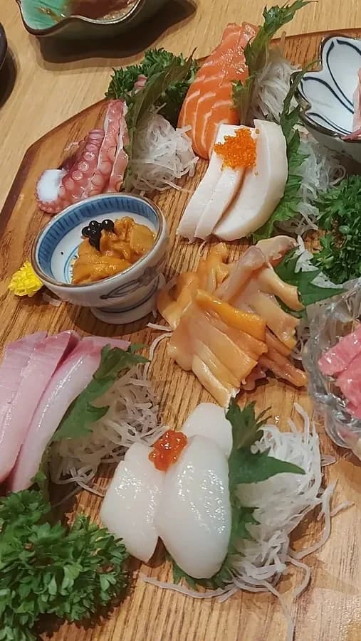 Chefs slice fish as you step inside