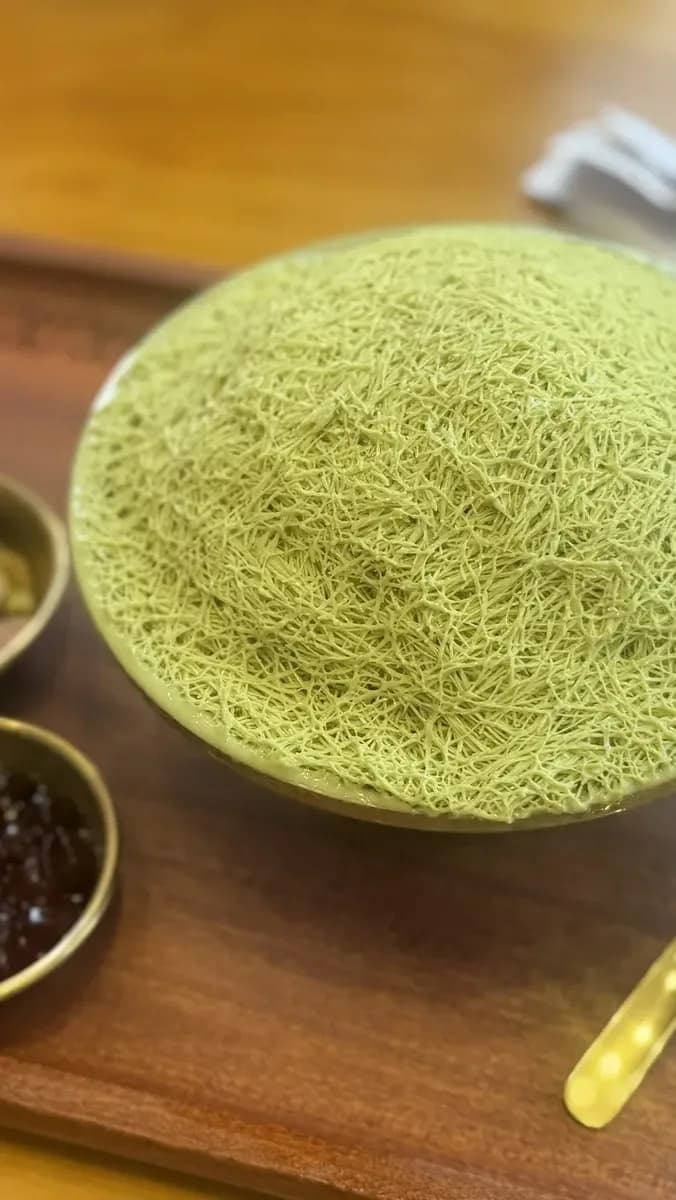 You walk in and see fluffy bingsu topped with matcha